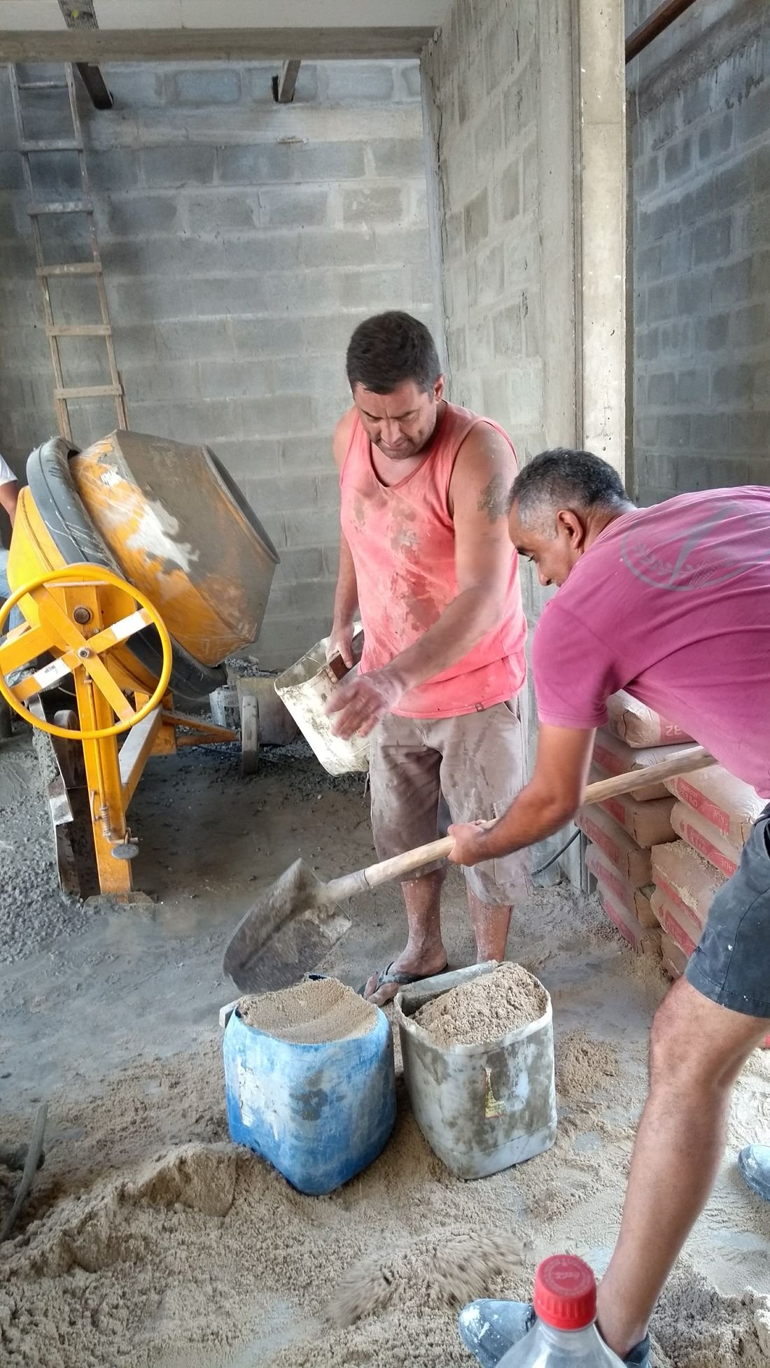 Voluntários trabalhando com betoneira
